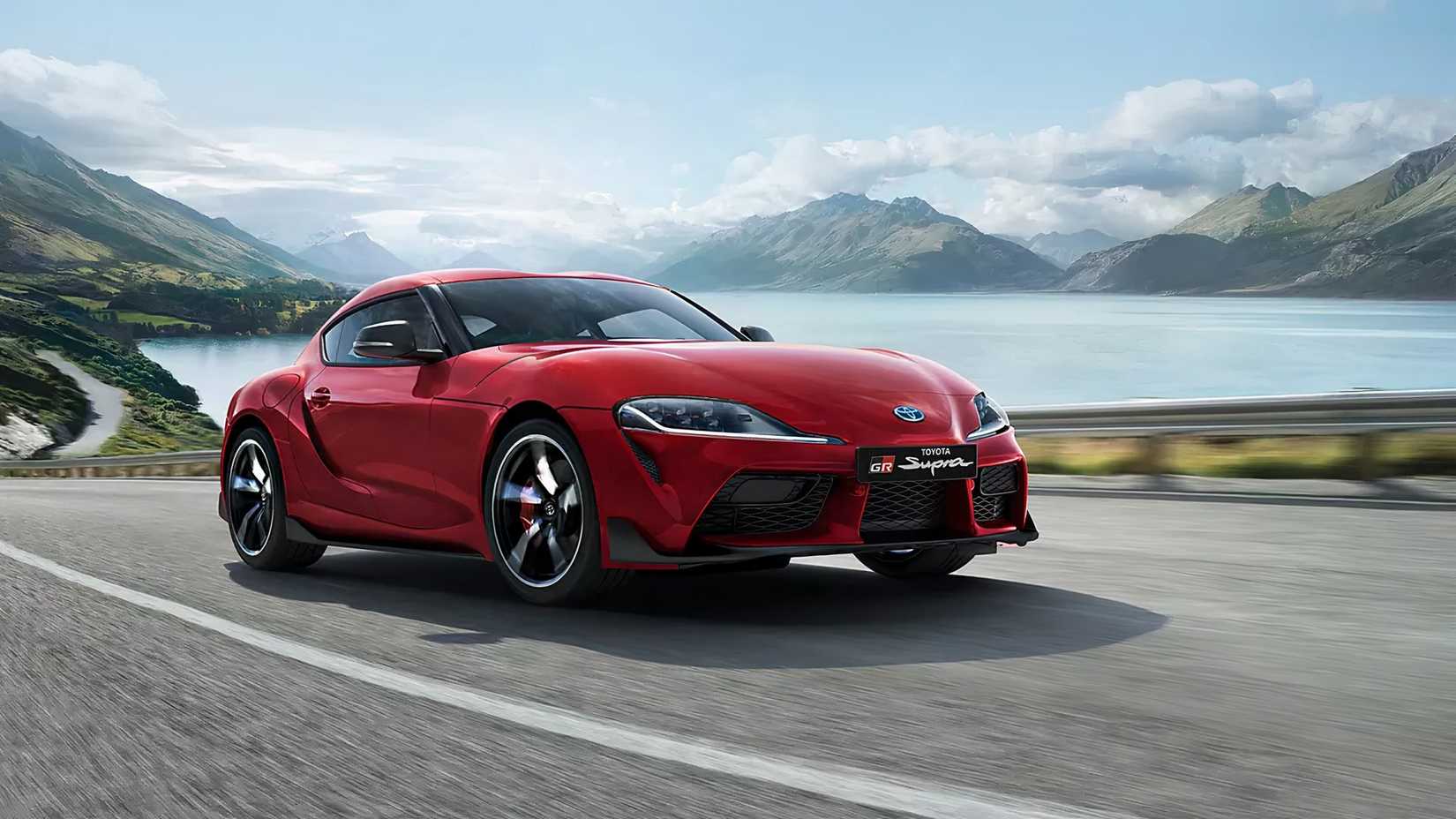 2024 Toyota GR Supra 3.0 Premium in red driving on lake road
