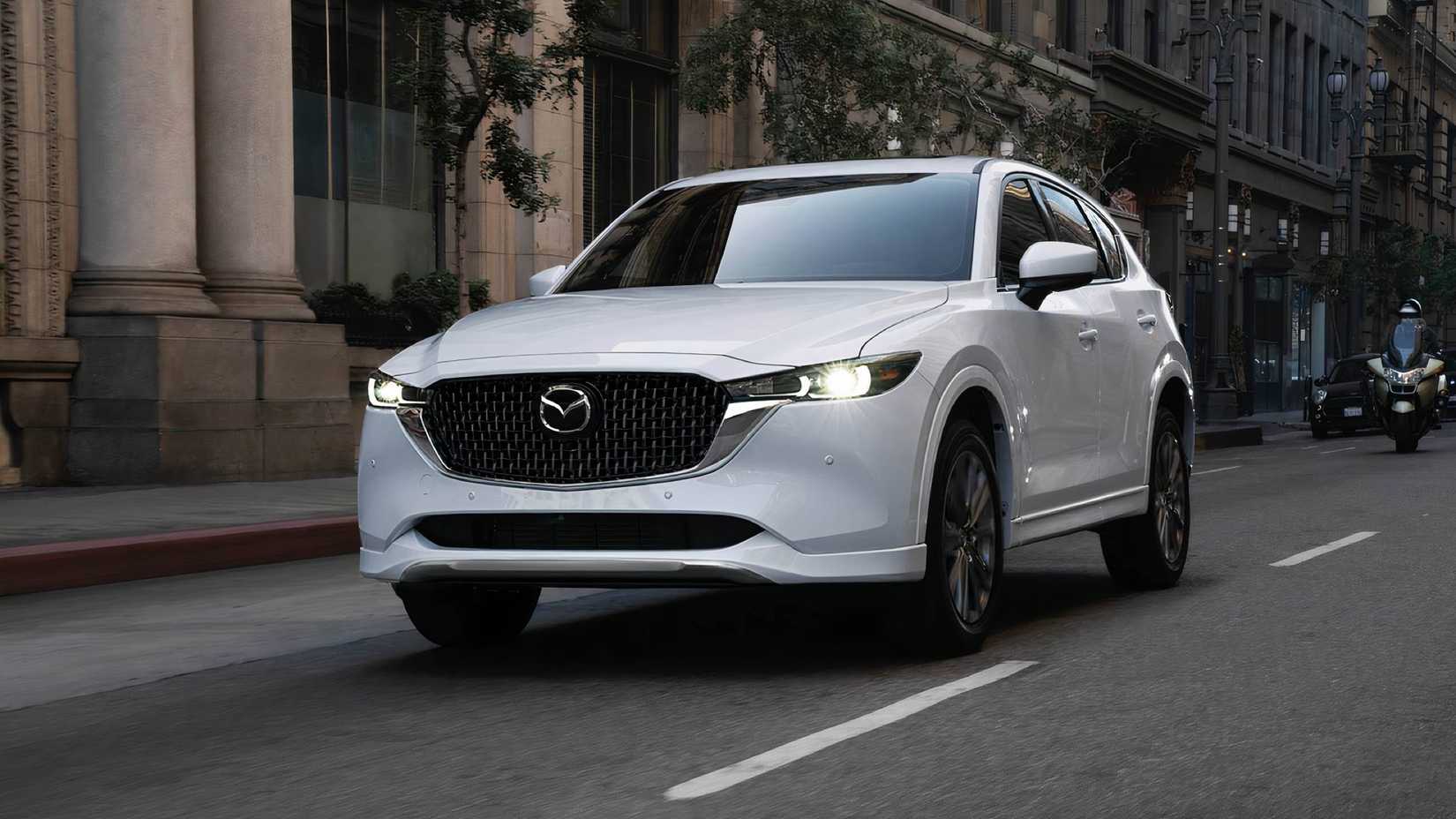 2025 Mazda CX-5 in white driving on city street