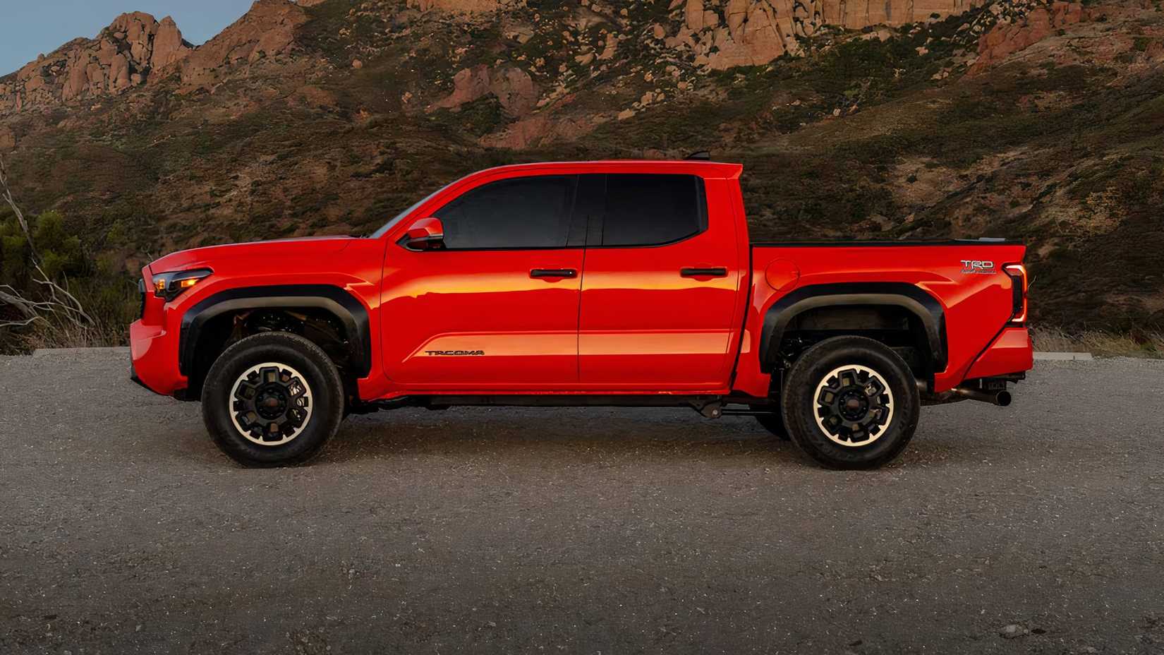 2025 Toyota Tacoma TRD Off-Road Crew Cab in orange parked