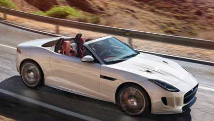 2017 Jaguar F-Type R in silver driving with roof down on mountain road