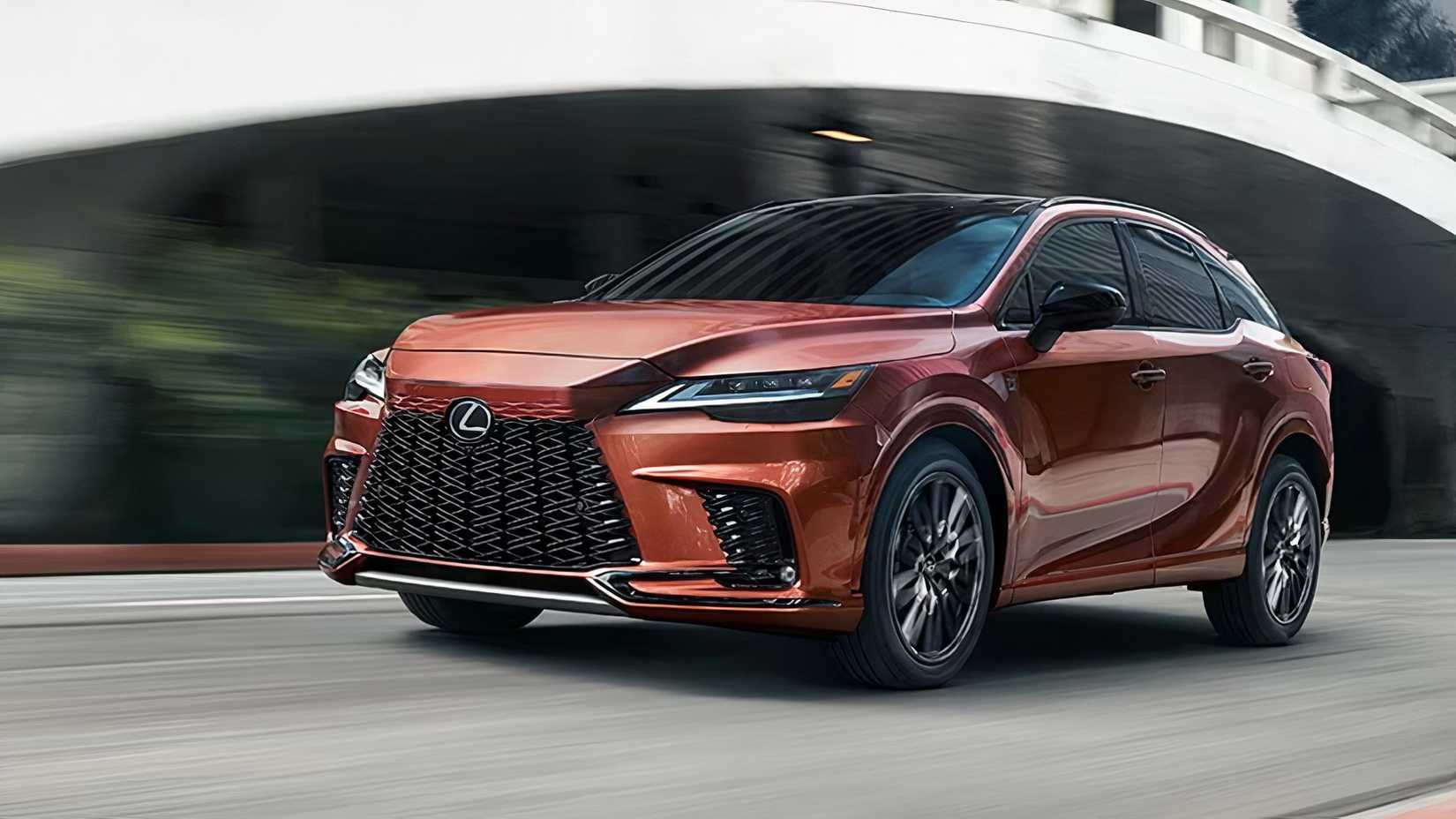 2025 Lexus RX in bronze driving on city street