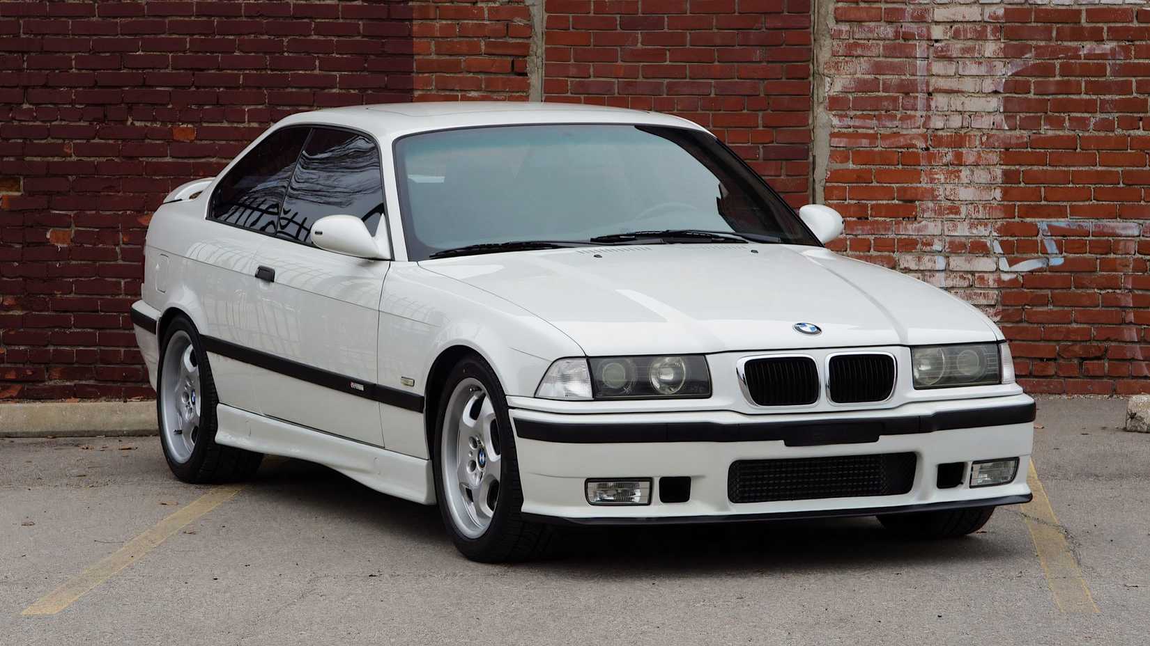 1998 BMW M3 Coupe in white parked in front of wall