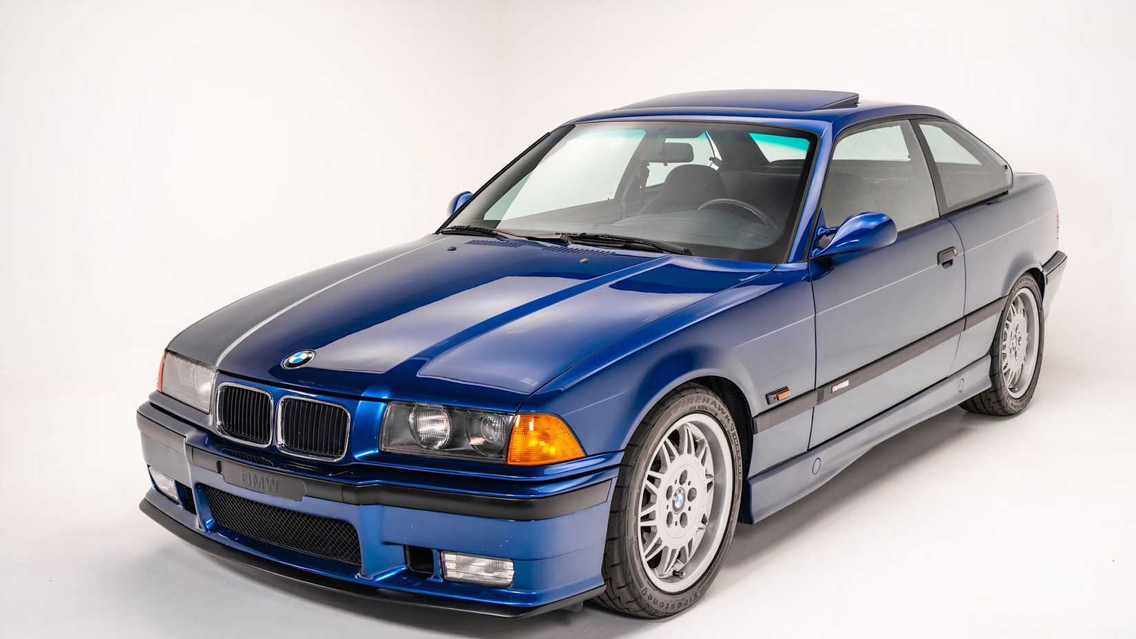 1994 BMW M3 Coupe featuring S50B30 engine in blue parked in studio