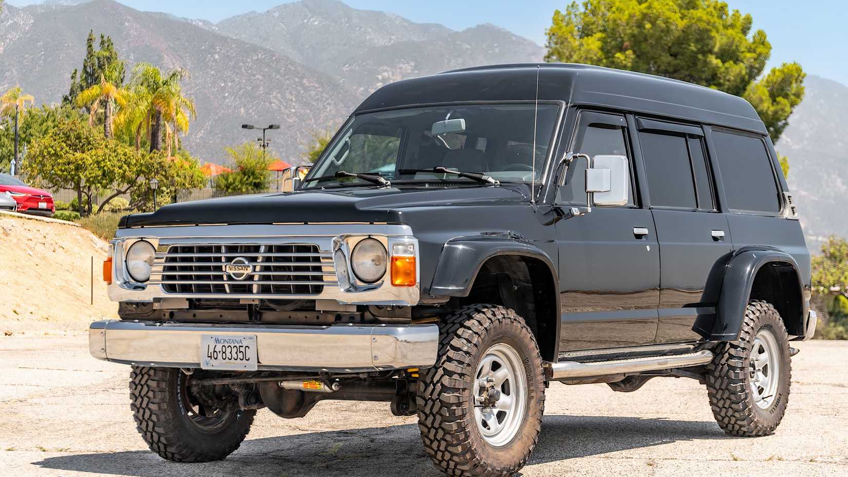 1995 Nissan Patrol in black parked in parking lot