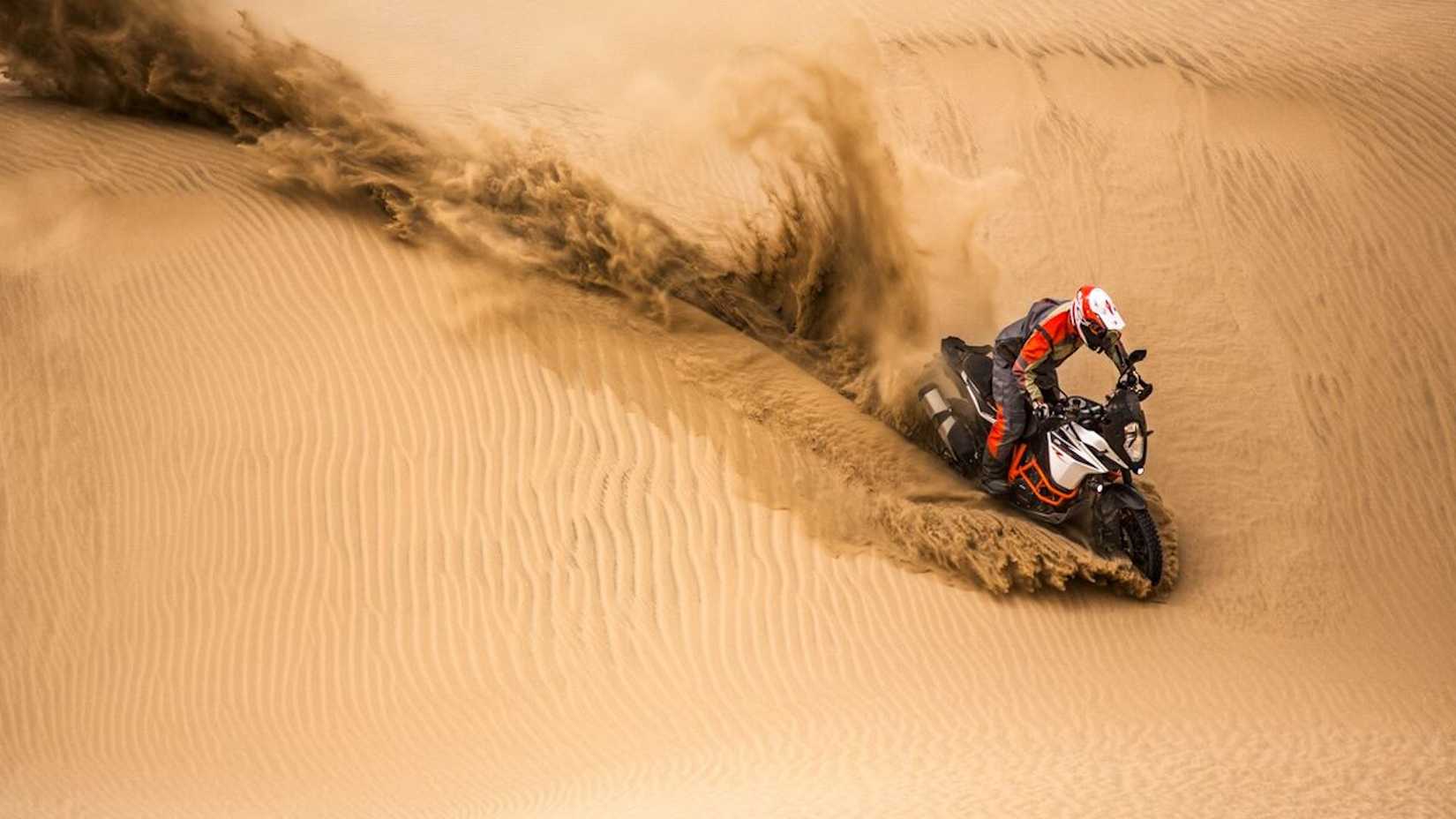 Ariel shot of a 2017 KTM 1090 ADVENTURE R riding over dunes