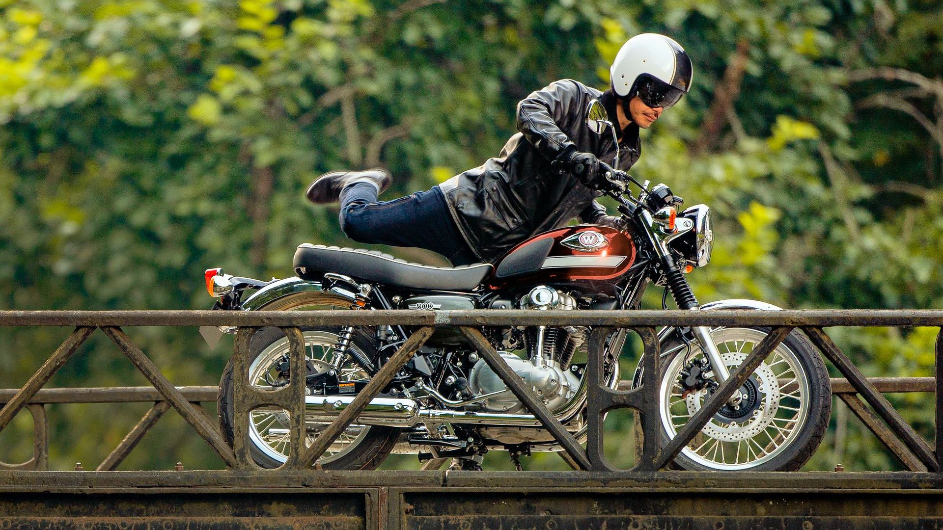 Rider mounting a 2025 Kawasaki W800