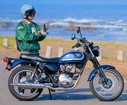 Piloto ao lado de uma Kawasaki W230 2025