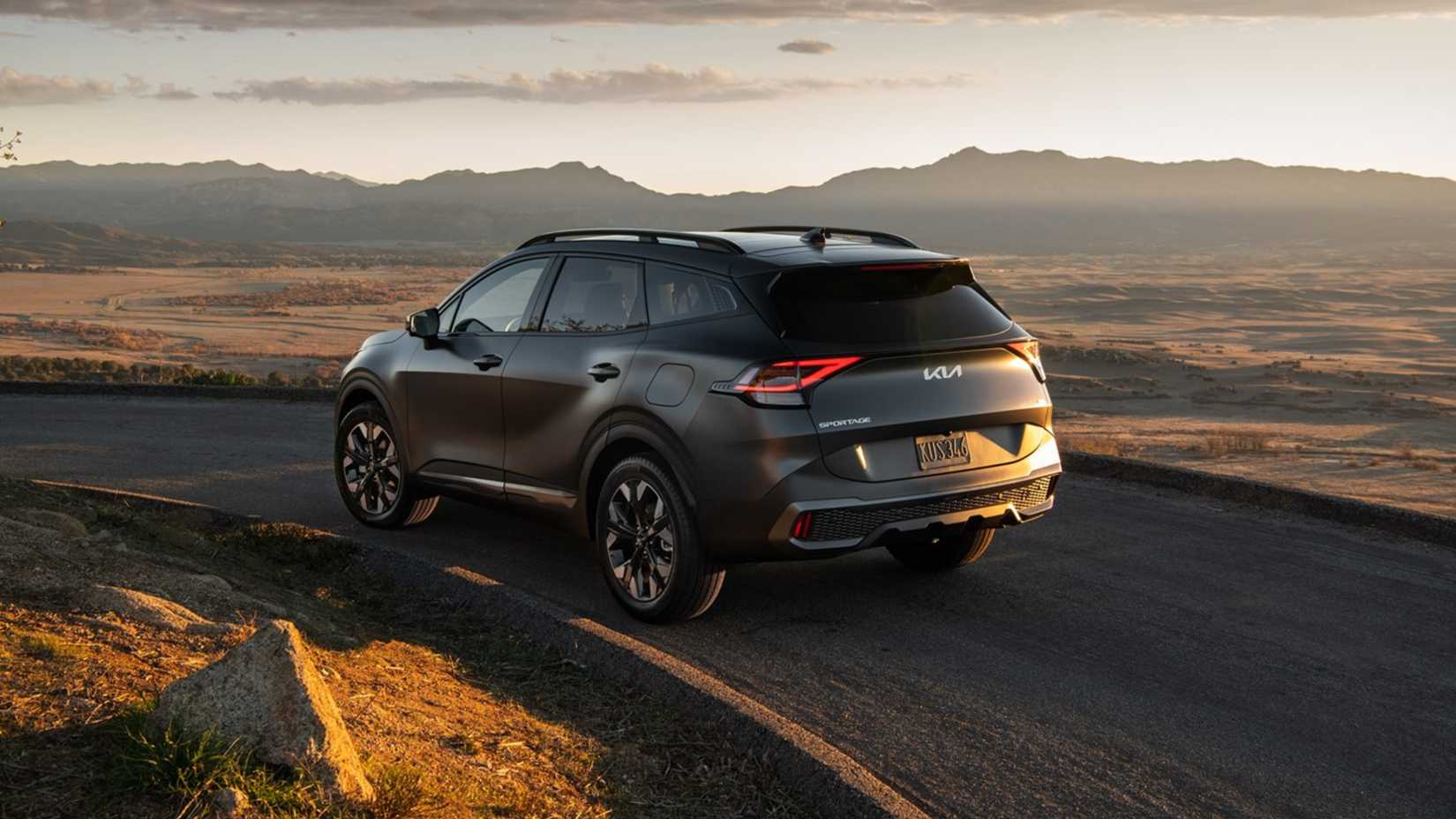 2025 Kia Sportage PHEV rear 3/4 driving on the road