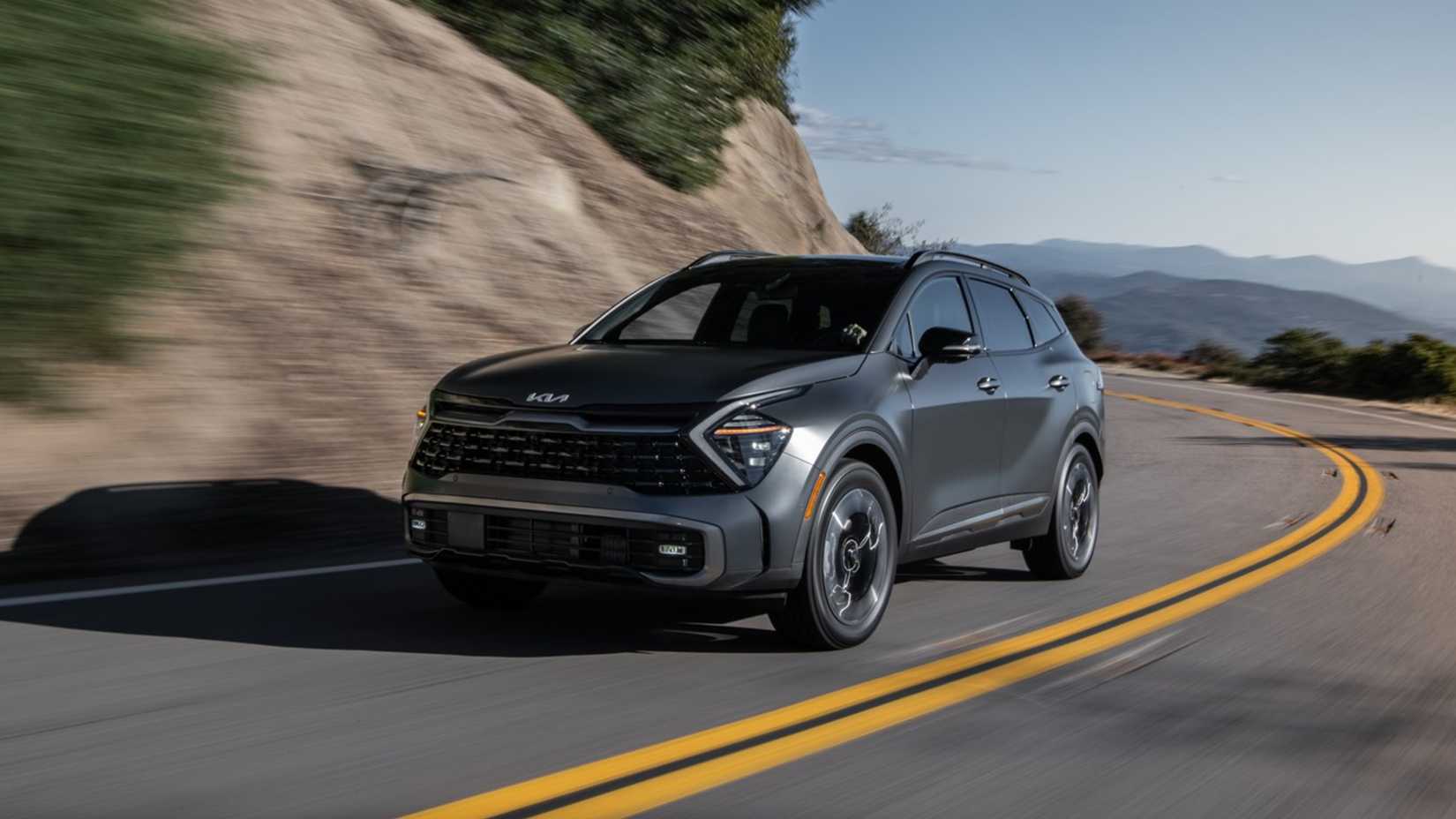 2025 Kia Sportage PHEV in gray being driven on road