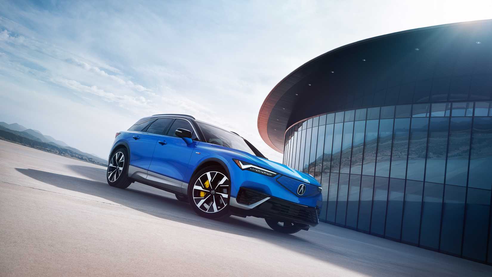 Front 3/4 shot of a blue Acura ZDX All-Electric parked 