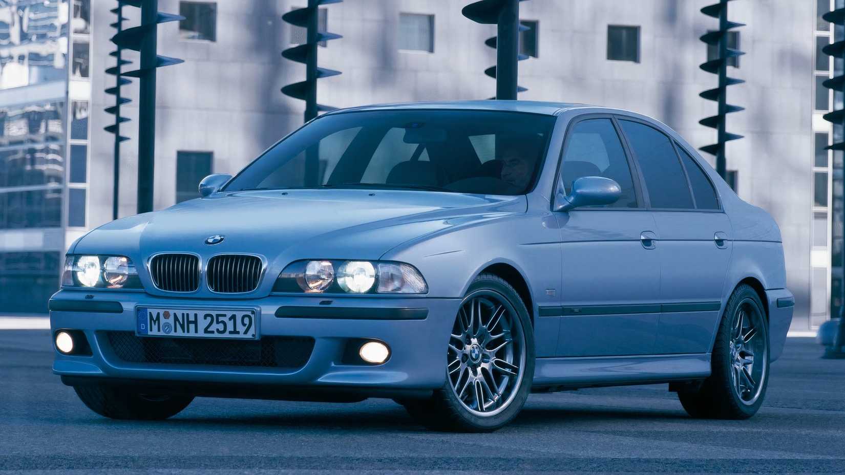 A BMW E39 M5 in front of a building, front 3/4