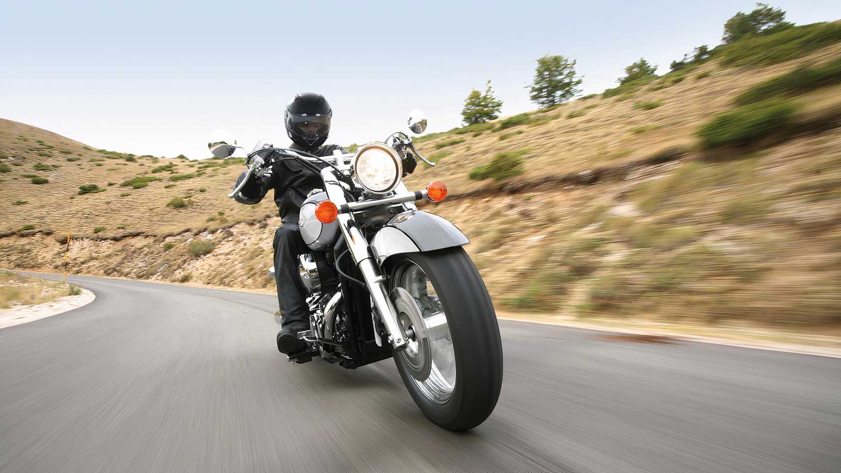 Honda Shadow accelerating along a mountain road front fascia cinematic shot