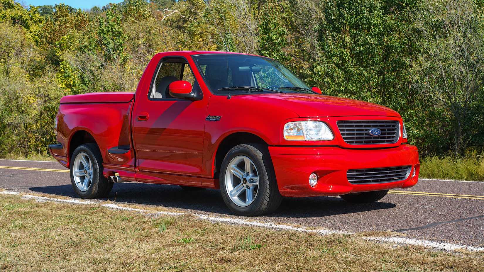 2004 Ford F-150 SVT Lightning in red parked on street