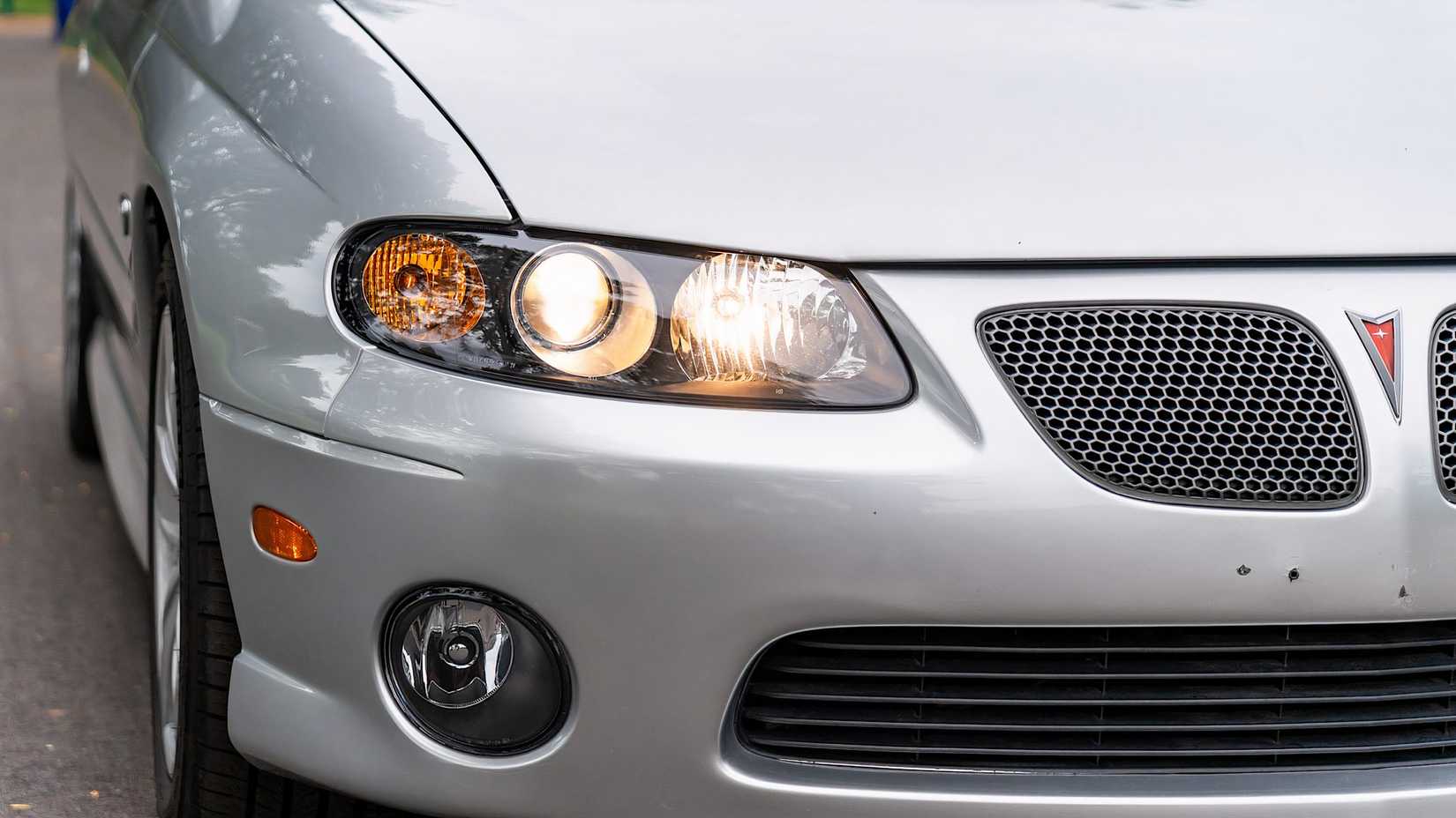 2004 Pontiac GTO in silver front end showing grille and headlight