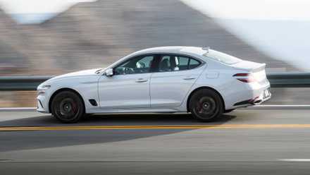 2025 Genesis G70 3.3T Sport Advanced in white driving on mountain road