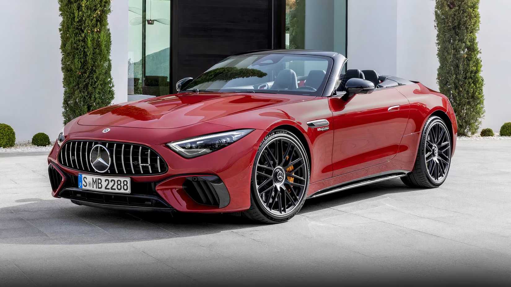 2025 Mercedes-AMG SL 63 Roadster in red parked on driveway with roof down
