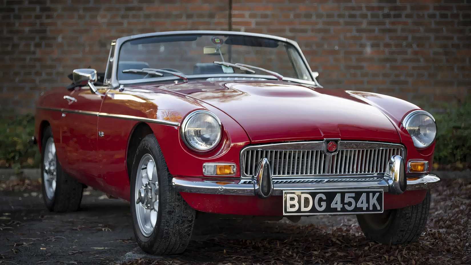 1972 MG B V8 Roadster in red parked against wall