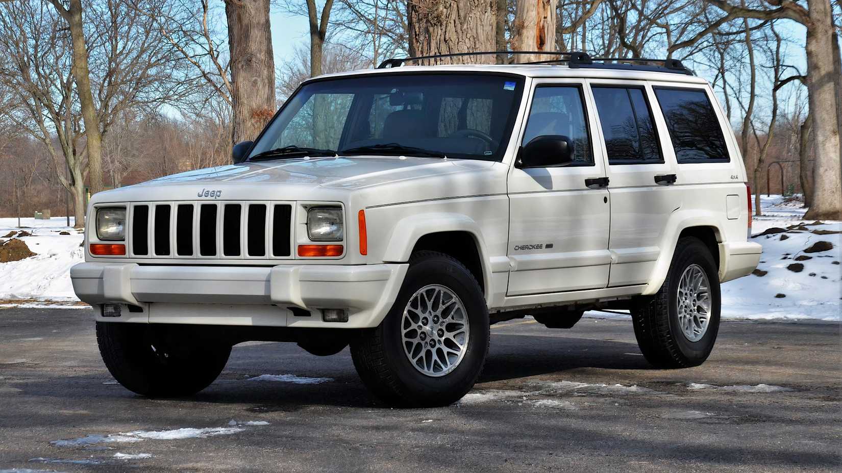 1999 Jeep Cherokee Limited in white parked in parking lot