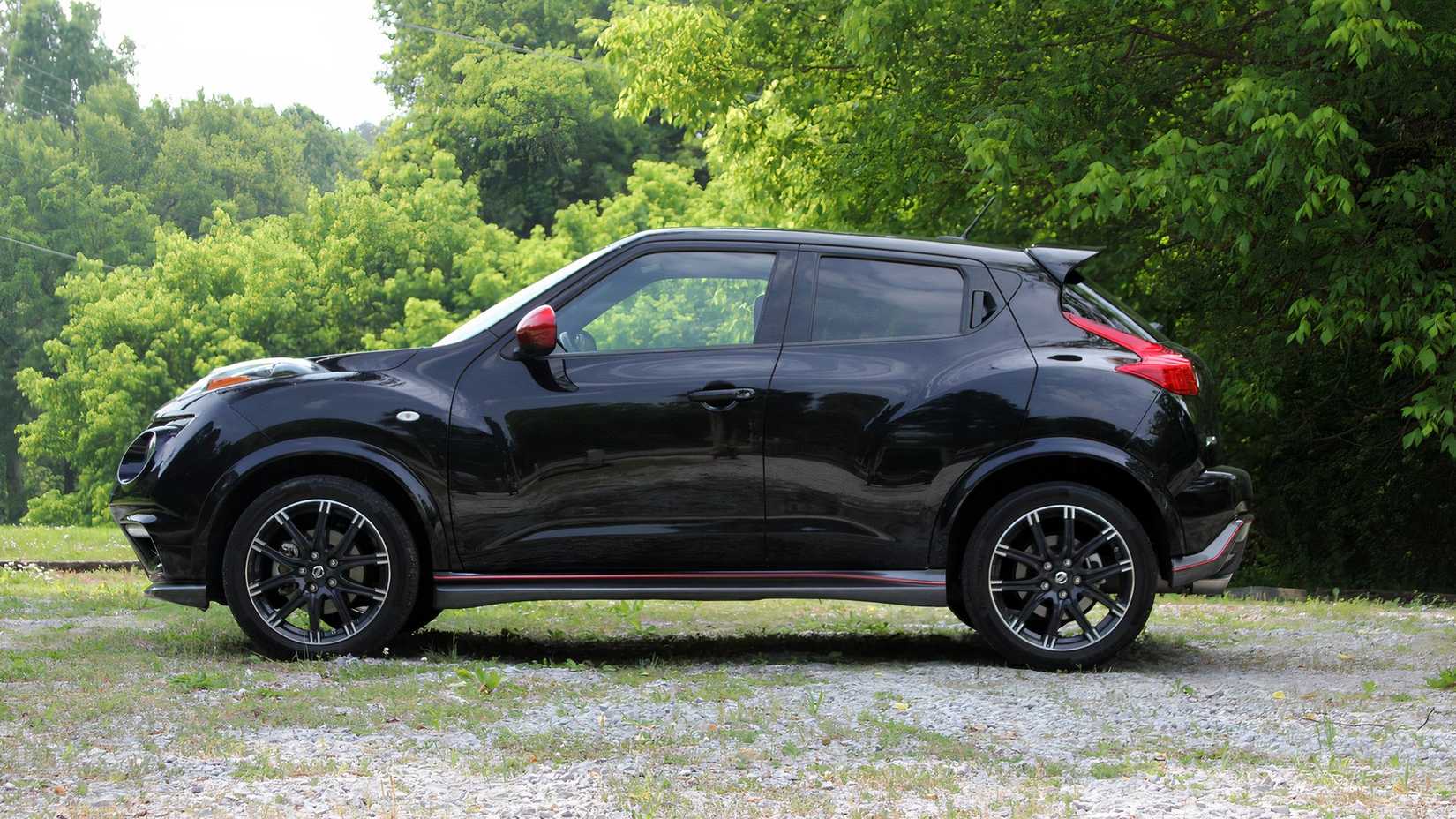 Side shot of a black 2013 Nissan Juke Nismo parked off-road