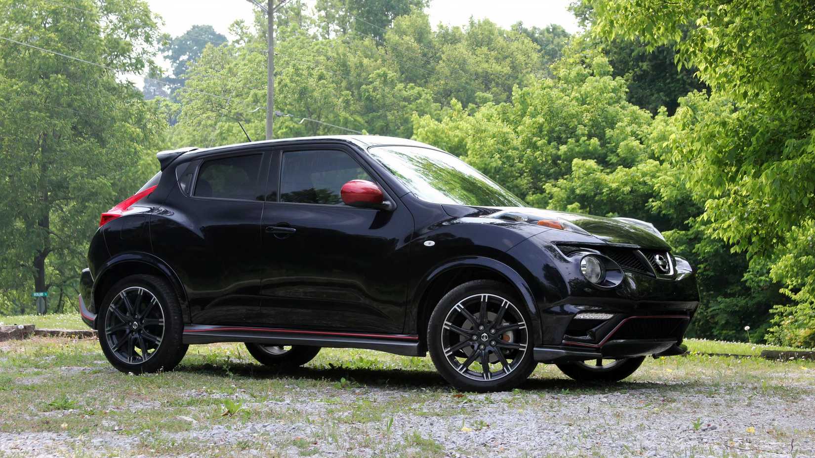 Front 3/4 shot of a black 2013 Nissan Juke Nismo parked off-road