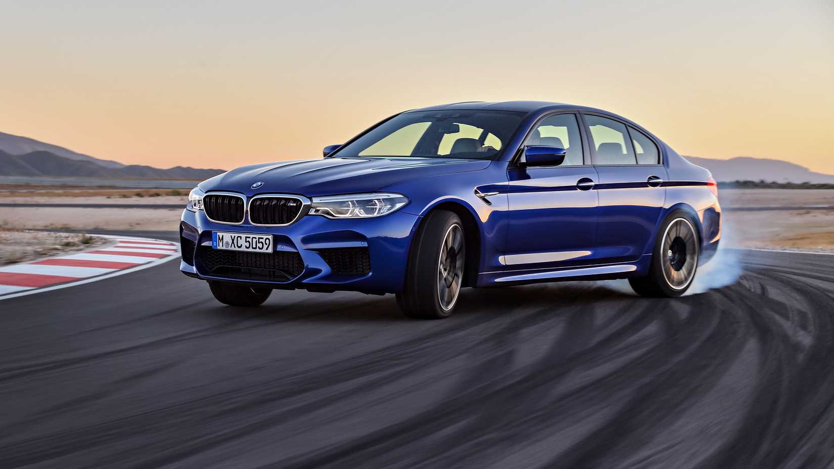 2018 BMW M5 in blue being driven on track