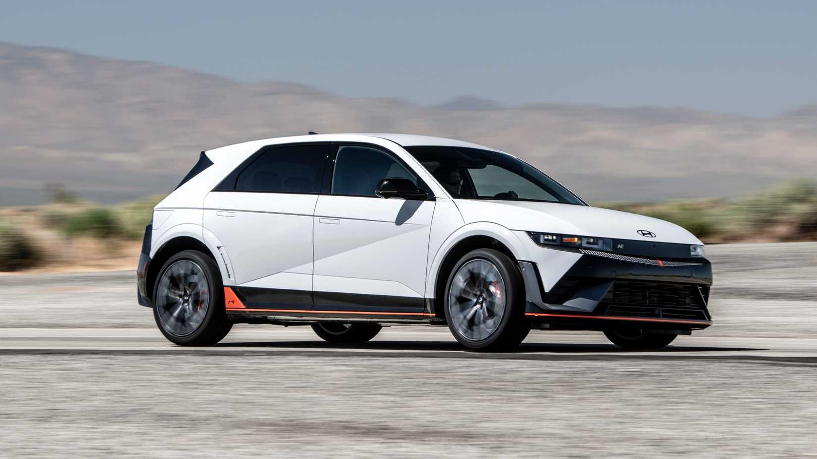 Front three-quarters driving image of a white 2025 Hyundai Ioniq 5 N