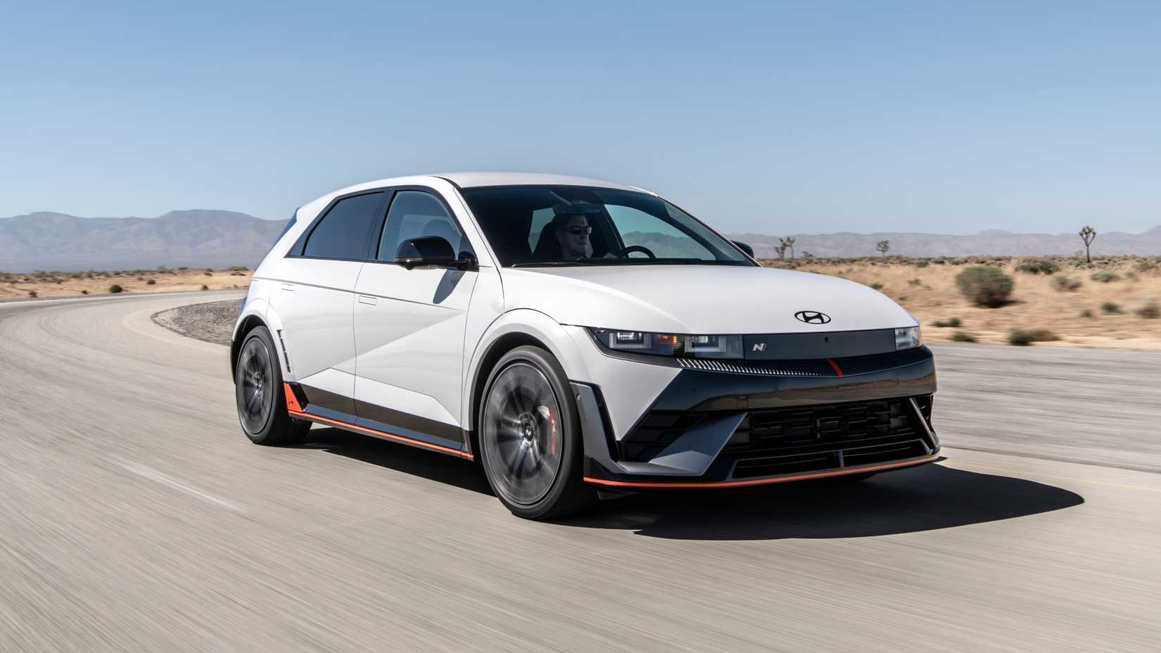 Front three-quarters driving image of a white 2025 Hyundai Ioniq 5 N