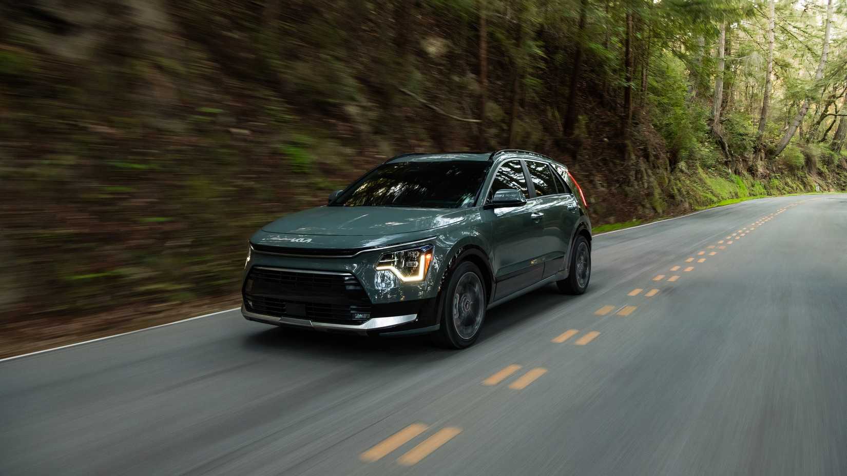 2025 Kia Niro in green being driven on road