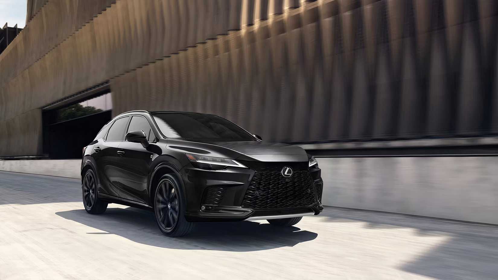 2025 Lexus RX in black driving on city road