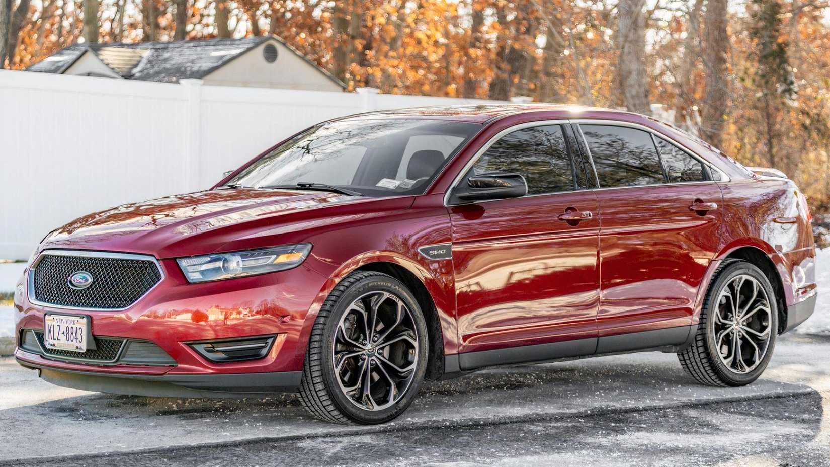 2013 Ford Taurus SHO in red parked on driveway