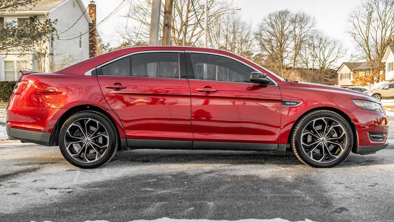 2013 Ford Taurus SHO in red parked on driveway