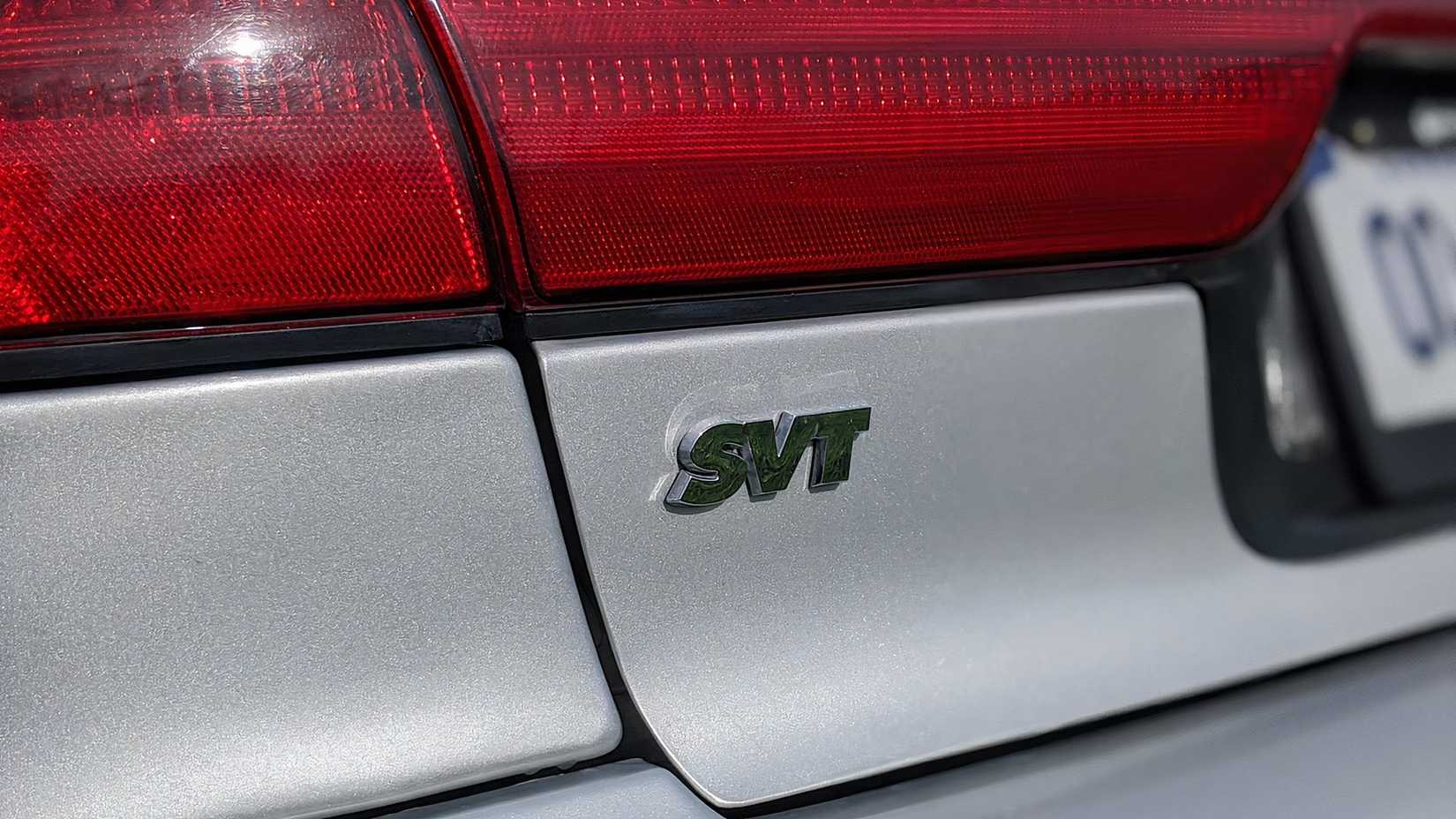 Close-up shot of the 1999 Ford Contour SVT badge