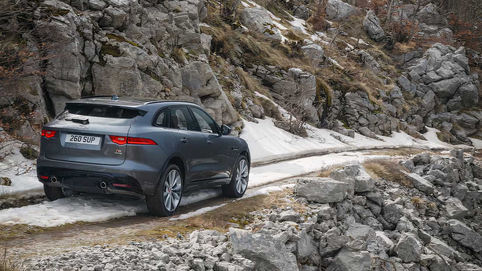 2017 Jaguar F-Pace S in silver driving on mountain track