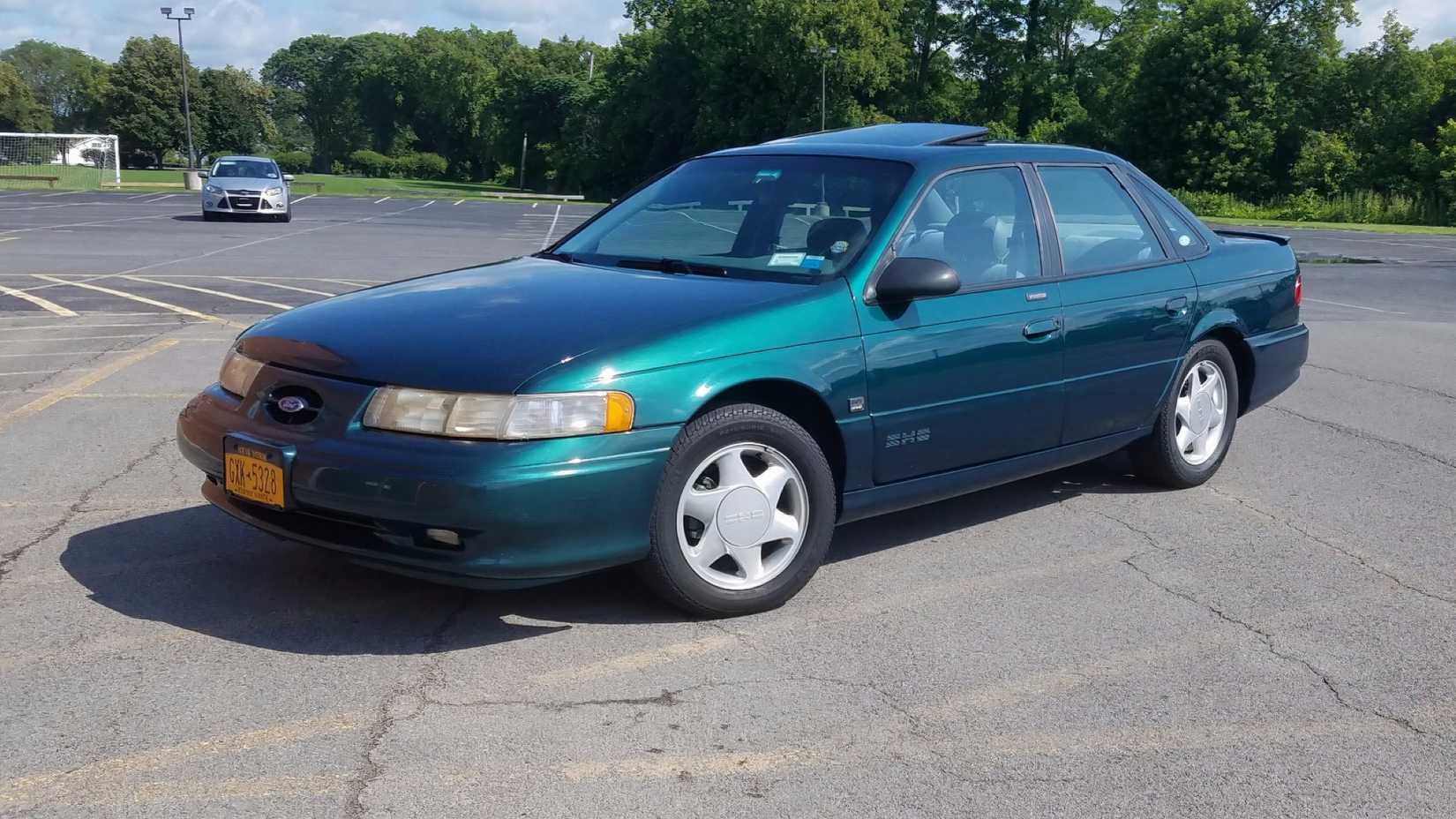 1994 Ford Taurus SHO in blue parked in parking lot
