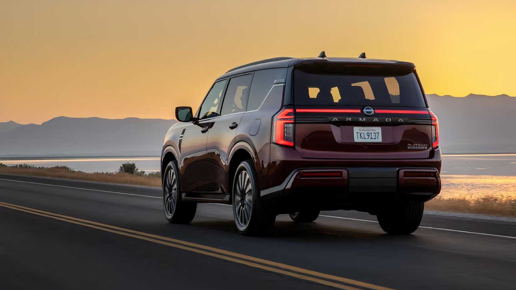 2025 Nissan Armada in red driving next to shore