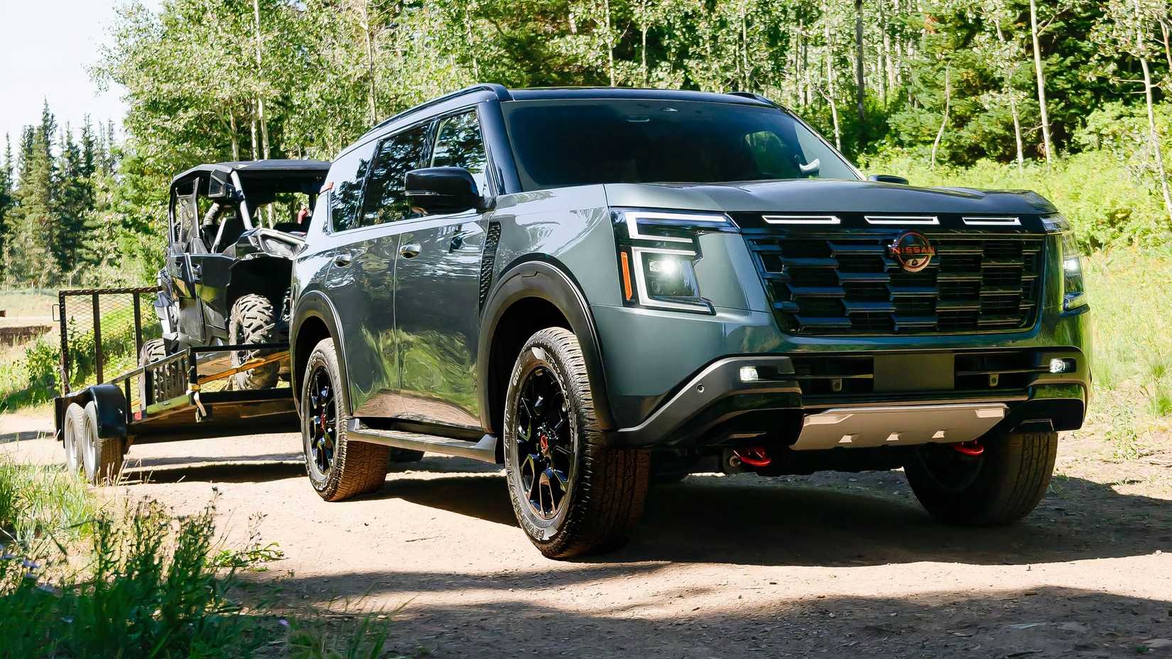 2025 Nissan Armada in green towing trailer