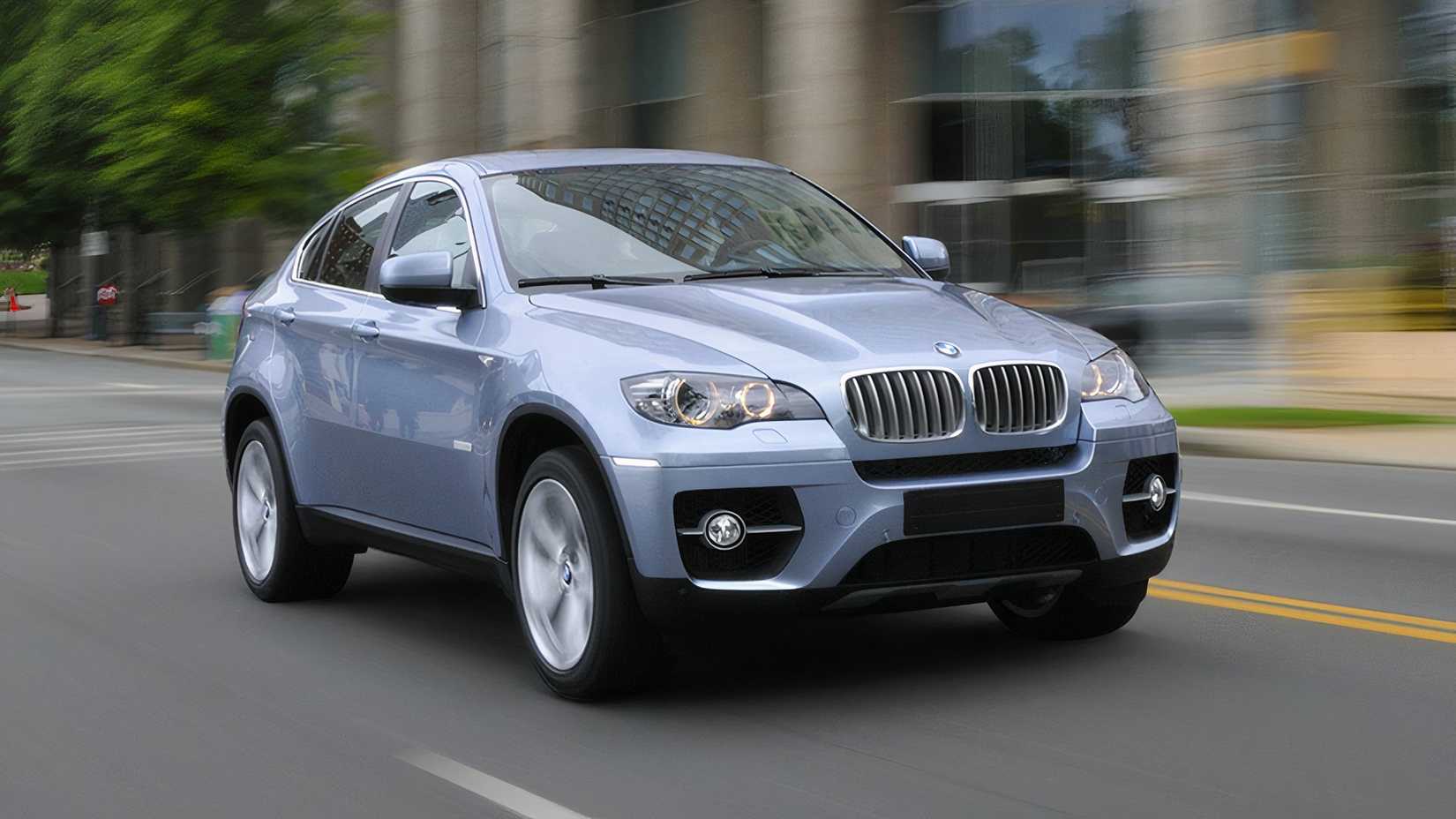 Driving shot of a silver 2010 BMW ActiveHybrid X6 on a city street in front 3/4 view