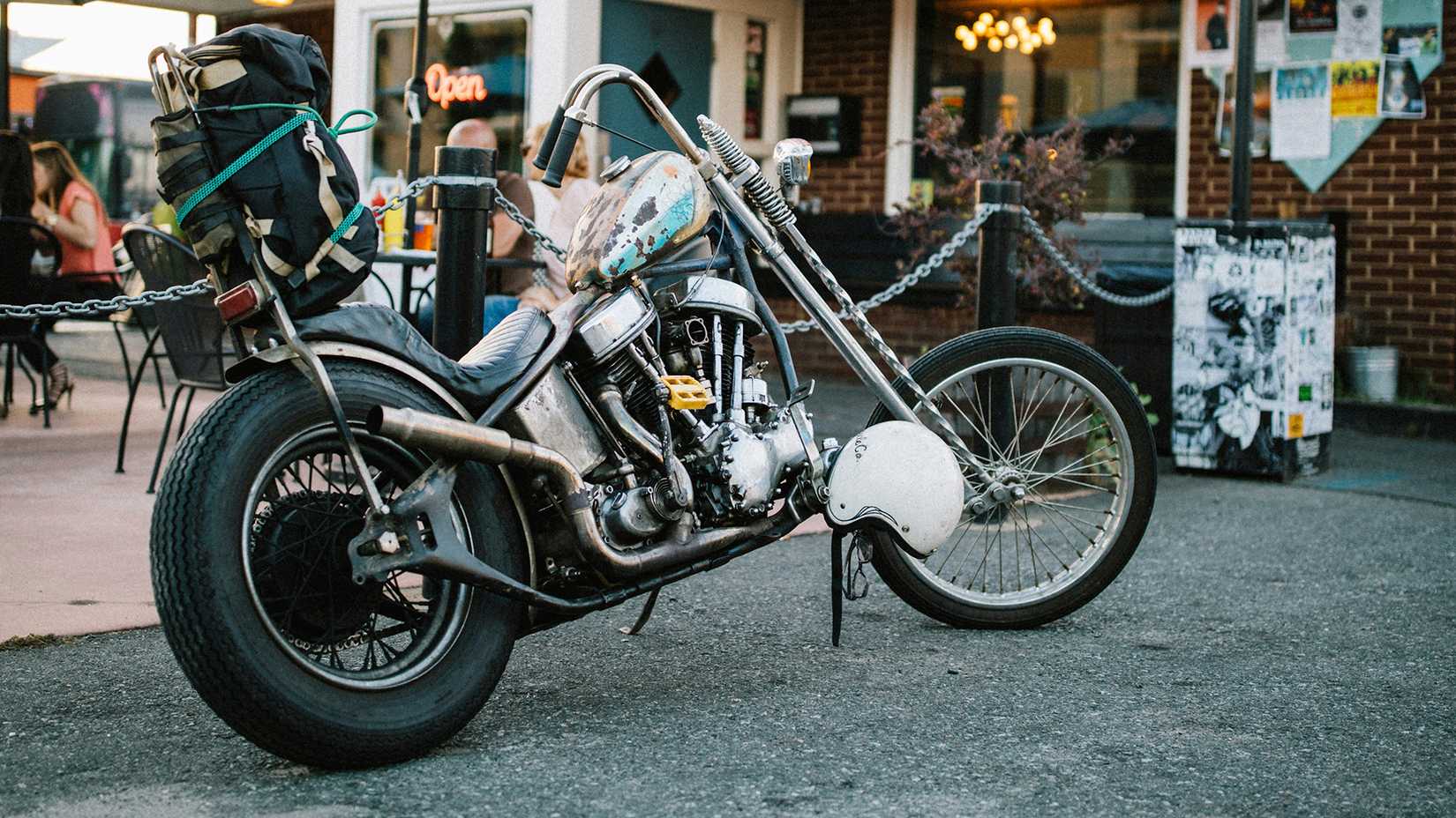 Custom helicopter parked outside a cafe