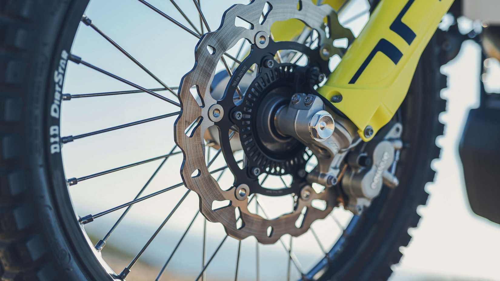 Close-up 3/4 shot of 2023 Husqvarna 701 Enduro front wheel hub and brake components