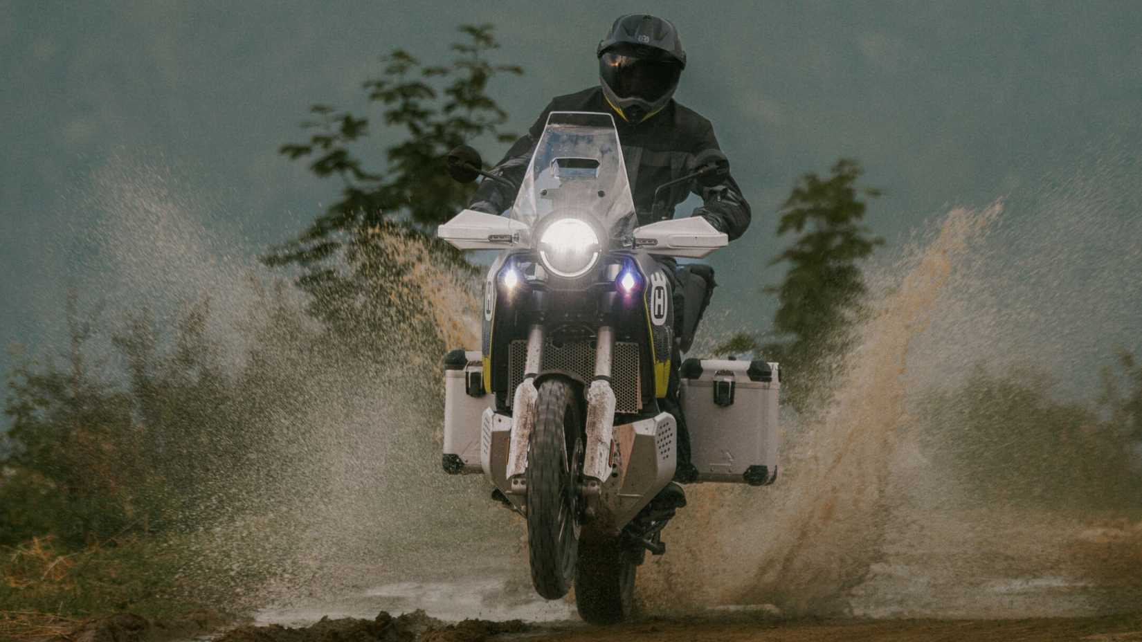 2025 Husqvarna Norden 901 Expedition popping a wheelie on mud hd wallpaper