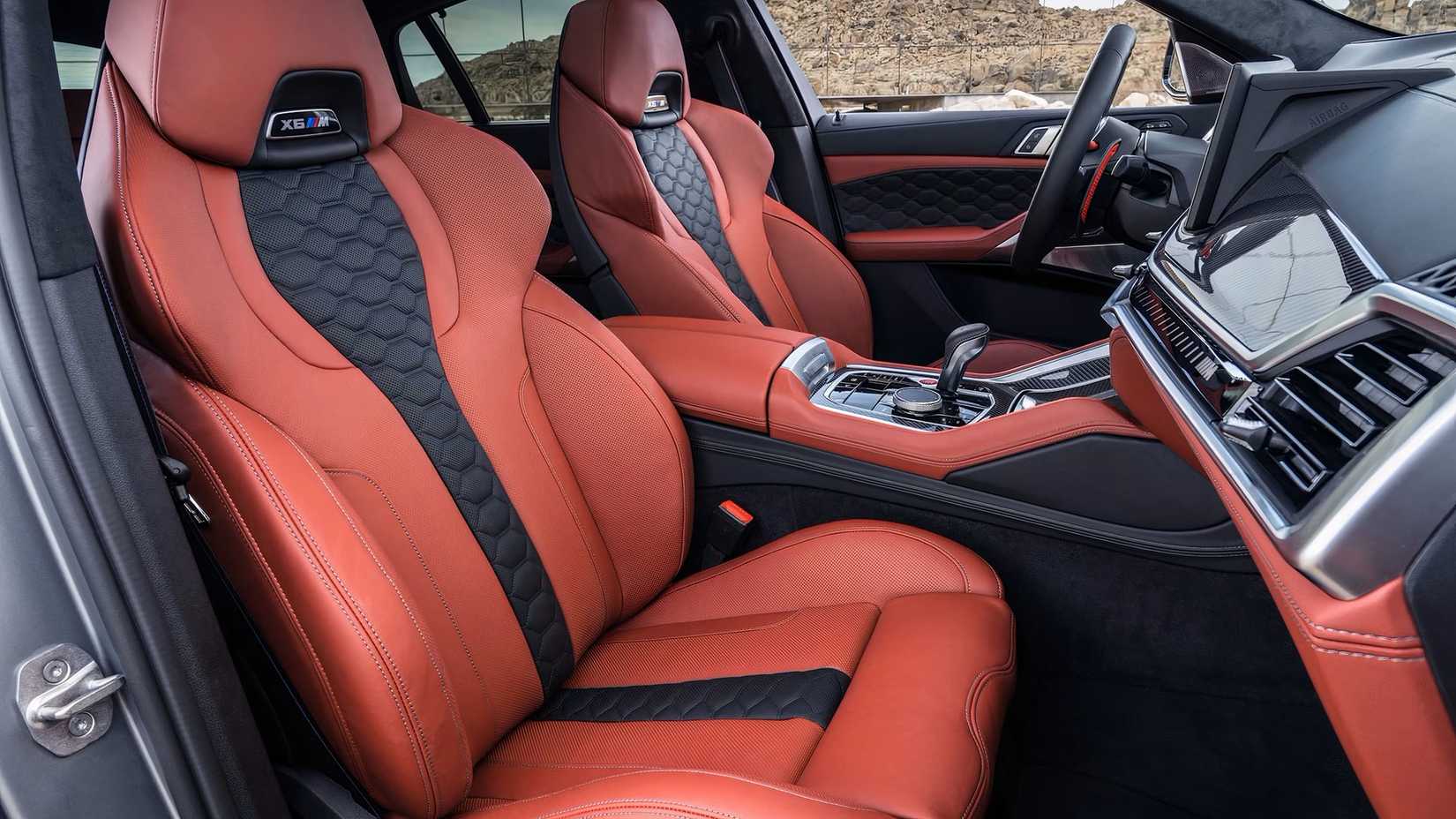 Interior shot of a 2025 BMW X6 M showing front seats