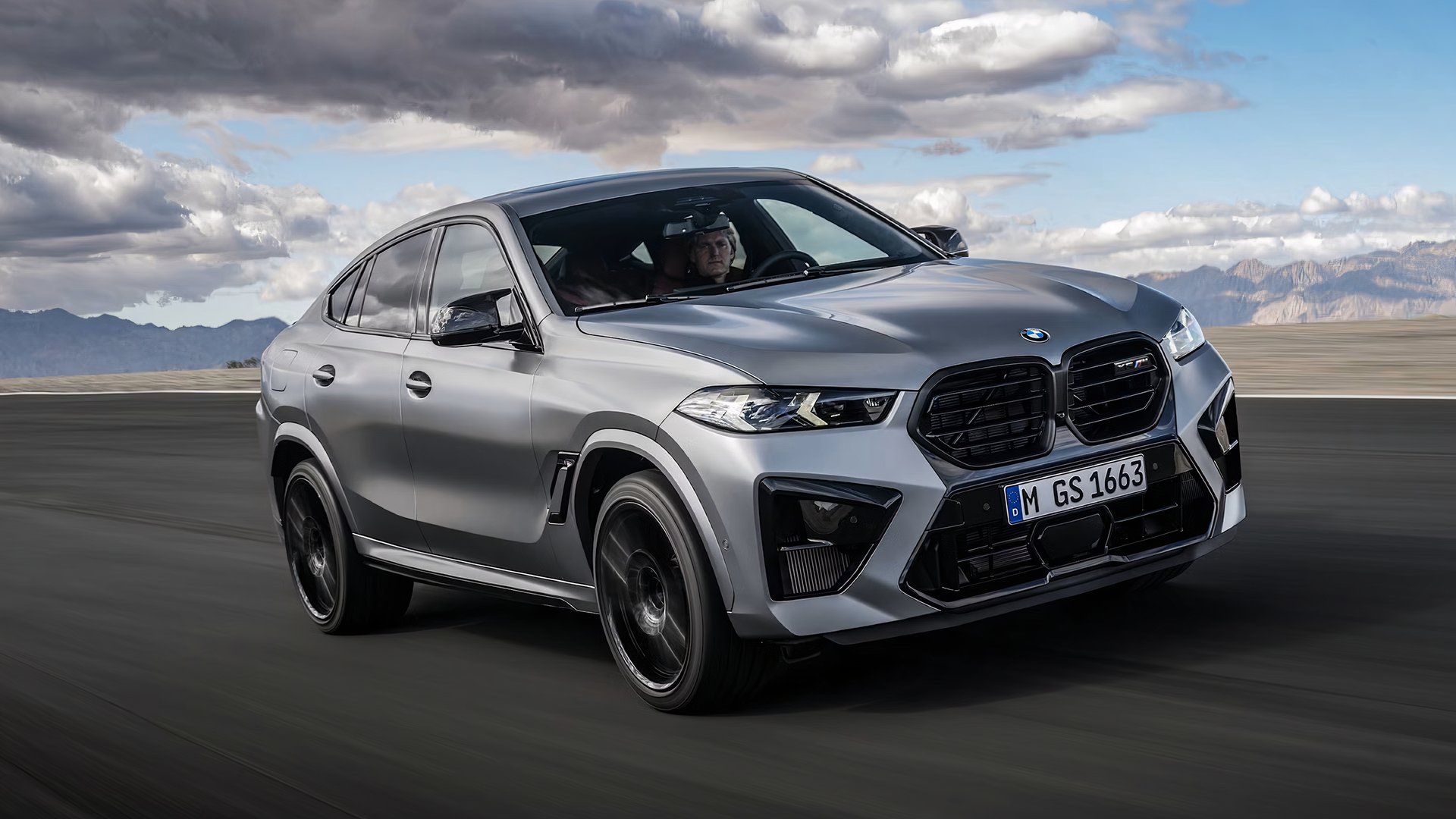 2025 BMW X6 M in silver being driven