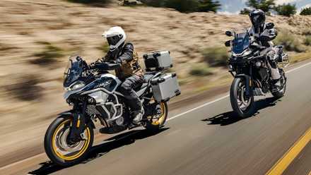 Cinematic shot of 2025 CFMoto Ibex 800 E driving on the road