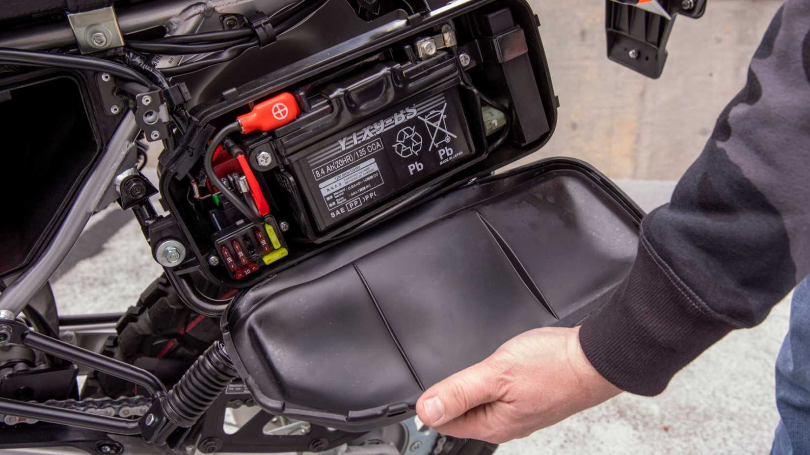 Honda XR650L dual-sport motorcycle sealed battery box close-up shot