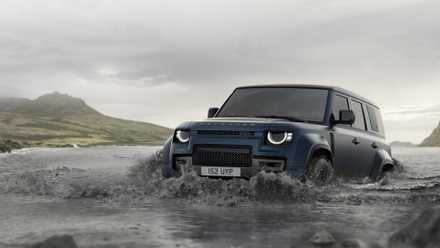 2026 Land Rover Defender in blue wading through water