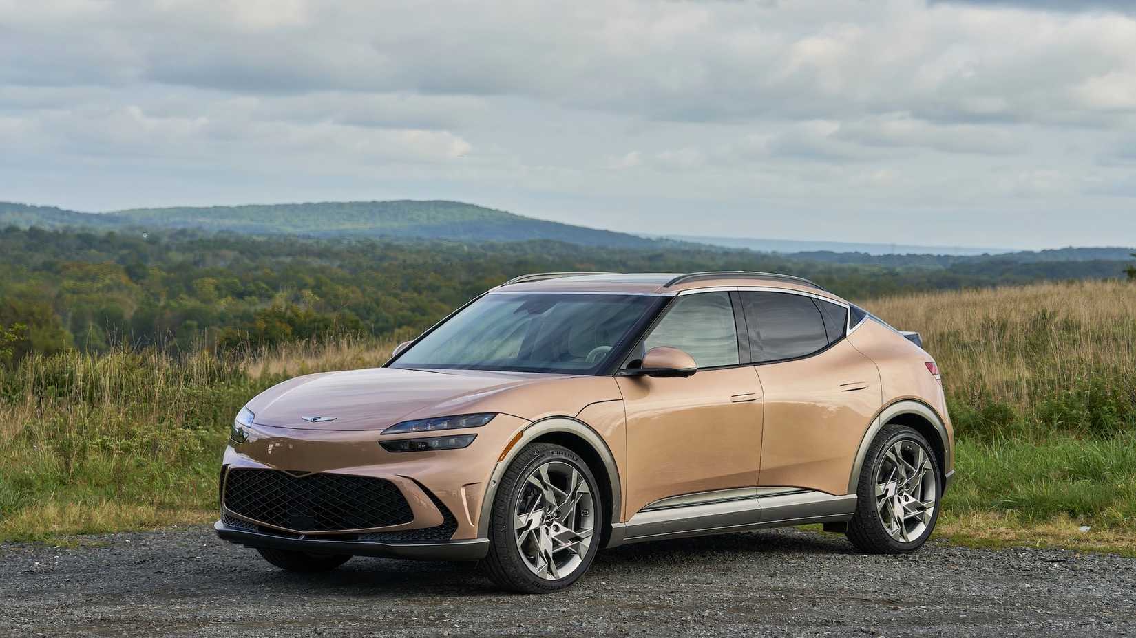 Genesis GV60 in gold parked off-road