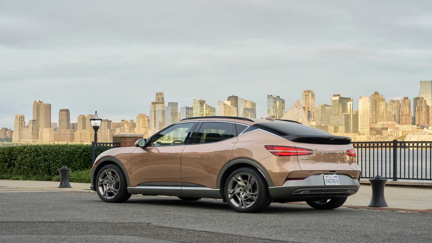 Genesis GV60 in gold parked next to river