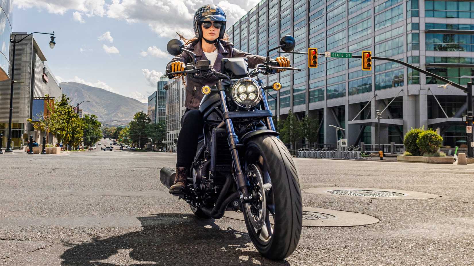 2025 Honda Rebel 1100 cruiser bike on the road front third quarter view