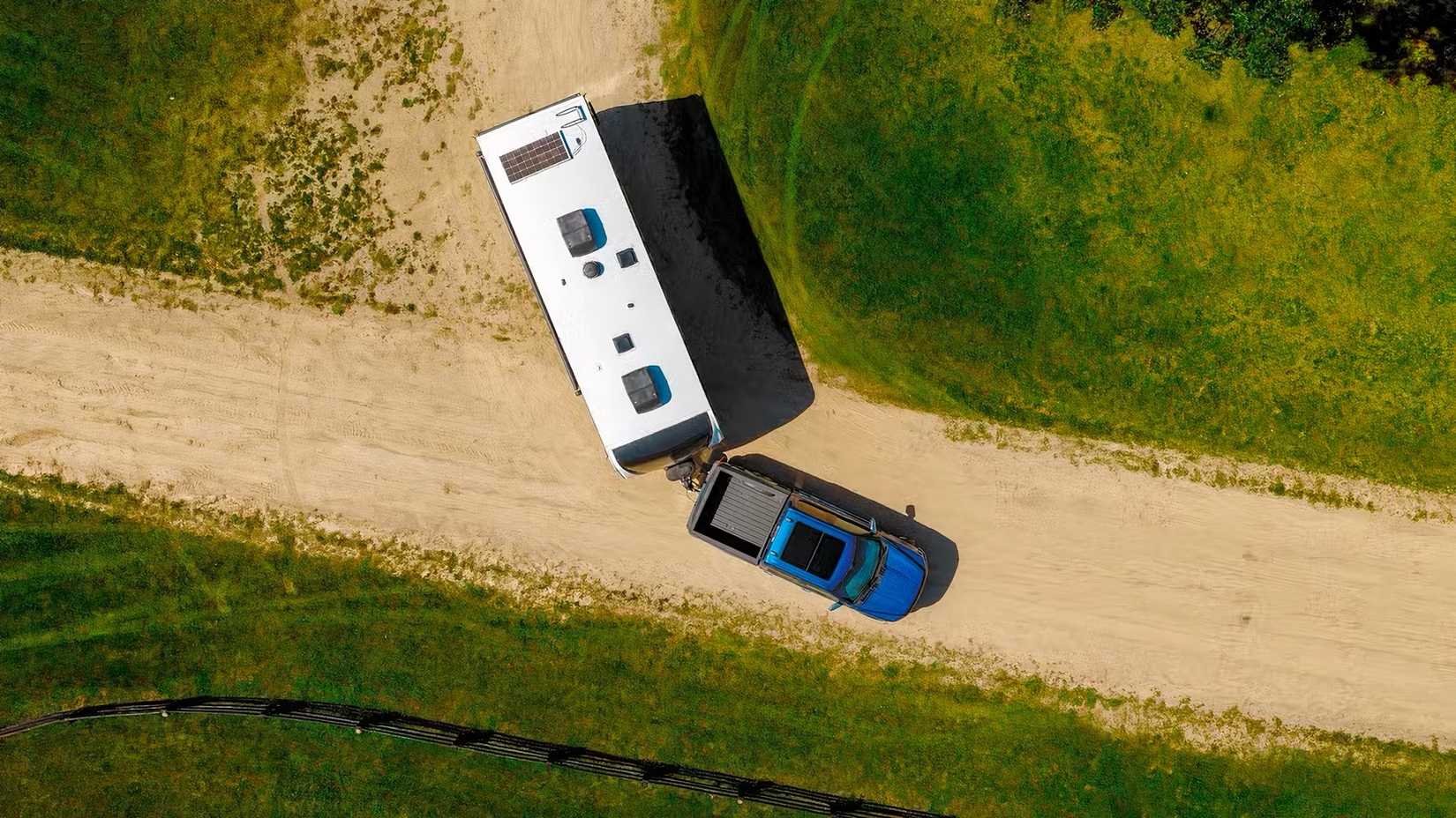 2025 Ford F-150 in blue towing caravan