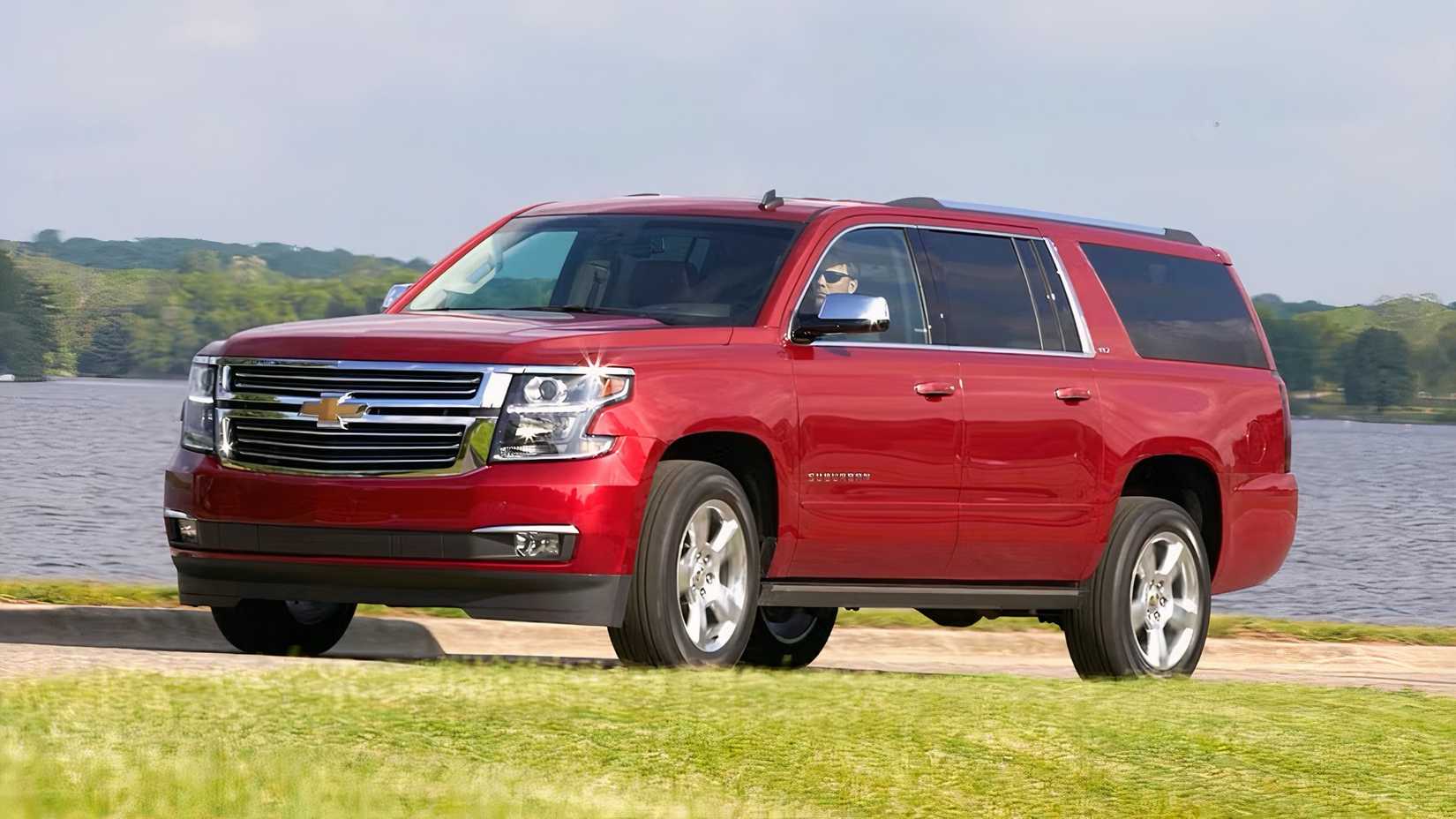 2019 Chevrolet Suburban in red parked by lake